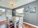 Well-lit dining room showcasing hardwood floors, neutral paint, and a view of the exterior at 26619 Bimini Dr, Tavares, FL 32778