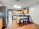 Well-appointed kitchen with a breakfast bar, wood cabinets, granite countertops, and stainless steel appliances at 26619 Bimini Dr, Tavares, FL 32778