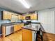 This well-lit kitchen features stainless steel appliances, wood cabinets and a granite topped island at 26619 Bimini Dr, Tavares, FL 32778