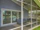 Relaxing screened patio featuring cozy seating and a modern fire pit, with serene lake views at 26619 Bimini Dr, Tavares, FL 32778