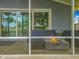 Relaxing screened patio featuring cozy seating and a modern fire pit, perfect for outdoor entertaining at 26619 Bimini Dr, Tavares, FL 32778