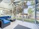 Enjoy the outdoors in this cozy screened porch with comfortable seating and scenic water views at 26619 Bimini Dr, Tavares, FL 32778