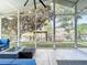 Relax on the screened porch offering waterfront views and an inviting outdoor seating area at 26619 Bimini Dr, Tavares, FL 32778