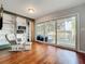 Bright sun room with wood floors, sliding glass doors, and view of a backyard patio at 26619 Bimini Dr, Tavares, FL 32778