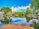 Picturesque waterfront view with a private dock, calm water, and beautiful sky reflections at 26619 Bimini Dr, Tavares, FL 32778