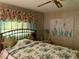 Bedroom with artwork, floral valances, and a decorative lamp at 313 Palo Verde Dr, Leesburg, FL 34748