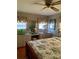Cozy bedroom with a built-in vanity, mirrored wall, and floral accents at 313 Palo Verde Dr, Leesburg, FL 34748
