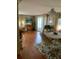 Dining room with wood floors, dining table, chairs, wicker furniture, decor, and a sliding glass door at 313 Palo Verde Dr, Leesburg, FL 34748
