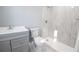 Modern bathroom featuring stylish vanity, toilet, and walk-in shower with tiled surround at 316 Betty Ln, Mascotte, FL 34753