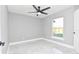 Bedroom featuring a modern ceiling fan, a bright window, and sleek gray color scheme at 316 Betty Ln, Mascotte, FL 34753
