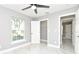 Bedroom with gray walls, tile floors, ceiling fan, and closet at 316 Betty Ln, Mascotte, FL 34753