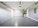 Garage with painted walls, epoxy floor, and water heater at 316 Betty Ln, Mascotte, FL 34753