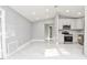 Open-concept kitchen with white cabinets, stainless steel appliances, and recessed lighting at 316 Betty Ln, Mascotte, FL 34753