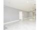 Bright, open-concept living room featuring gray walls, recessed lighting, and tile floors at 316 Betty Ln, Mascotte, FL 34753