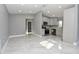 Open living space featuring recessed lights, tile floor, kitchen with stainless steel appliances, and neutral paint at 316 Betty Ln, Mascotte, FL 34753