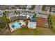 Community aerial view showcasing the clubhouse, pool, splash pad, playground, parking, and well-manicured landscaping at 3235 Buoy Cir, Winter Garden, FL 34787