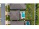 Aerial view of a home with a pool, patio, fire pit, and landscaped backyard in a desirable neighborhood at 3235 Buoy Cir, Winter Garden, FL 34787