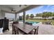 Inviting backyard with large outdoor dining table and chairs next to the pool and lush lawn at 3235 Buoy Cir, Winter Garden, FL 34787