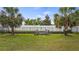 Private backyard with a fire pit area surrounded by lush greenery and a secure fence at 3235 Buoy Cir, Winter Garden, FL 34787