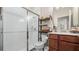Compact bathroom with a glass-enclosed shower, modern vanity, and tiled walls at 3235 Buoy Cir, Winter Garden, FL 34787
