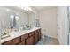 Bathroom featuring a double sink vanity, wood-look flooring, and bright lighting at 3235 Buoy Cir, Winter Garden, FL 34787