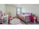 Charming bedroom with plush daybed, wood-look flooring, and playful decor for a cozy retreat at 3235 Buoy Cir, Winter Garden, FL 34787