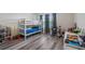 Spacious bedroom features a bunk bed, wood-look floors and lots of natural light for a great space at 3235 Buoy Cir, Winter Garden, FL 34787