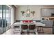 Bright dining room featuring a white table, modern light fixture, and sliding glass doors at 3235 Buoy Cir, Winter Garden, FL 34787