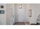 Bright foyer with wood-look tile, stylish lighting and white doors leading to another room at 3235 Buoy Cir, Winter Garden, FL 34787