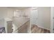 Bright hallway with wood-look flooring, staircase and a modern tree art decal on the wall at 3235 Buoy Cir, Winter Garden, FL 34787