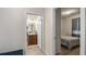 Hallway leading to a bedroom and bathroom, featuring tile flooring and neutral paint at 3235 Buoy Cir, Winter Garden, FL 34787