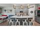Modern kitchen featuring stainless steel appliances, white countertop island with seating, and gray cabinets at 3235 Buoy Cir, Winter Garden, FL 34787