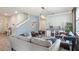 Bright living room with a cozy seating arrangement, modern decor, and staircase access at 3235 Buoy Cir, Winter Garden, FL 34787