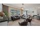 Cozy living space that flows to dining area, features large windows, and a neutral color palette at 3235 Buoy Cir, Winter Garden, FL 34787