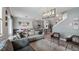 Spacious living room with open floor plan, dining area, modern furniture, and hardwood flooring at 3235 Buoy Cir, Winter Garden, FL 34787