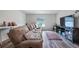Inviting living room with a plush sofa, wood-look flooring and abundant natural light from the window at 3235 Buoy Cir, Winter Garden, FL 34787