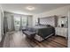 Spacious main bedroom boasts modern decor, wood-look flooring and plenty of natural light from the windows at 3235 Buoy Cir, Winter Garden, FL 34787