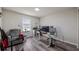 Functional home office with wood-look floors, modern desk setup, and comfortable seating area at 3235 Buoy Cir, Winter Garden, FL 34787