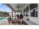 Comfortable covered patio with ceiling fans, ample seating, and views of the pool and fenced backyard at 3235 Buoy Cir, Winter Garden, FL 34787