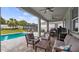Covered patio with outdoor seating, a grill and backyard with a pool surrounded by lush landscaping at 3235 Buoy Cir, Winter Garden, FL 34787