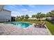 Sparkling pool surrounded by an elegant patio, lush landscaping, and lounging area for relaxation at 3235 Buoy Cir, Winter Garden, FL 34787