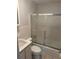 Bathroom features a toilet, sink and walk-in shower with sliding glass doors at 32737 Vista Ave, Leesburg, FL 34788