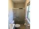 Bathroom features a toilet, sink and walk-in shower with sliding glass doors at 32737 Vista Ave, Leesburg, FL 34788