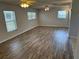 Spacious living room featuring wood-look flooring, ceiling fans, and natural light at 32737 Vista Ave, Leesburg, FL 34788