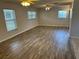 Spacious living room featuring wood-look flooring, ceiling fans, and natural light at 32737 Vista Ave, Leesburg, FL 34788