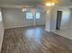 Bright living area featuring updated floors, ceiling fans, and access to the kitchen at 32737 Vista Ave, Leesburg, FL 34788