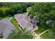 Aerial view of a home with mature trees, manicured lawn, and a two-car garage at 33222 Irongate Dr, Leesburg, FL 34788