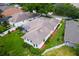 Aerial view of a home featuring a screened-in lanai, landscaped yard, and neutral paint at 33222 Irongate Dr, Leesburg, FL 34788