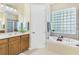 Bathroom with double sink vanity, soaking tub, and separate shower at 33222 Irongate Dr, Leesburg, FL 34788