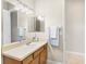 Bathroom with a vanity, large mirror, and neutral tile flooring at 33222 Irongate Dr, Leesburg, FL 34788